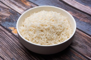 Aromatic Long Basmati cooked plain Rice is an Indian main course food, served in a bowl. selective focus