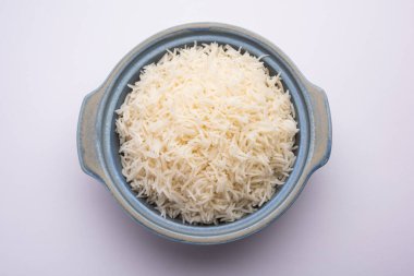 Aromatic Long Basmati cooked plain Rice is an Indian main course food, served in a bowl. selective focus