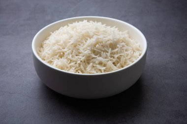 Aromatic Long Basmati cooked plain Rice is an Indian main course food, served in a bowl. selective focus
