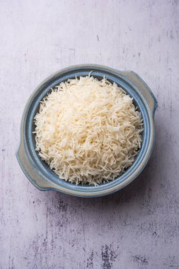 Aromatic Long Basmati cooked plain Rice is an Indian main course food, served in a bowl. selective focus
