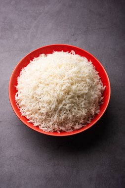 Aromatic Long Basmati cooked plain Rice is an Indian main course food, served in a bowl. selective focus