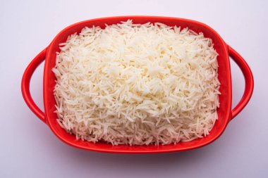 Aromatic Long Basmati cooked plain Rice is an Indian main course food, served in a bowl. selective focus