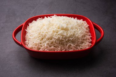 Aromatic Long Basmati cooked plain Rice is an Indian main course food, served in a bowl. selective focus