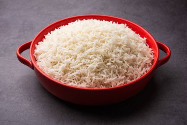 Aromatic Long Basmati cooked plain Rice is an Indian main course food, served in a bowl. selective focus