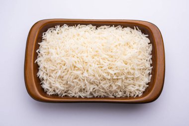 Aromatic Long Basmati cooked plain Rice is an Indian main course food, served in a bowl. selective focus