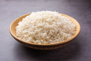 Aromatic Long Basmati cooked plain Rice is an Indian main course food, served in a bowl. selective focus