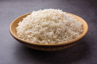 Aromatic Long Basmati cooked plain Rice is an Indian main course food, served in a bowl. selective focus