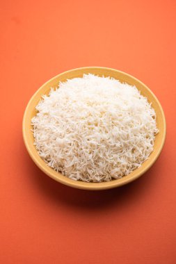 Aromatic Long Basmati cooked plain Rice is an Indian main course food, served in a bowl. selective focus