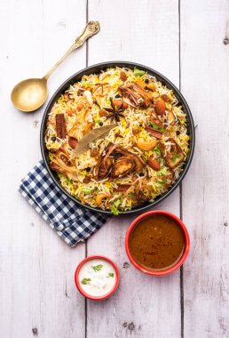 Kathal Biryani is made using raw jackfruit pieces cooked slowly with a variety of spices and mixed with basmati rice. served with curd and salan. Indian vegetarian food