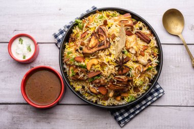 Kathal Biryani is made using raw jackfruit pieces cooked slowly with a variety of spices and mixed with basmati rice. served with curd and salan. Indian vegetarian food
