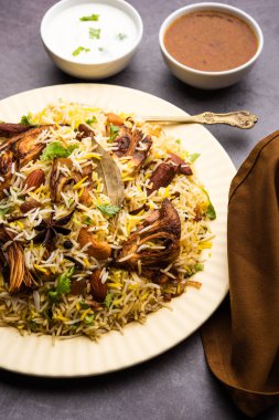 Kathal Biryani is made using raw jackfruit pieces cooked slowly with a variety of spices and mixed with basmati rice. served with curd and salan. Indian vegetarian food