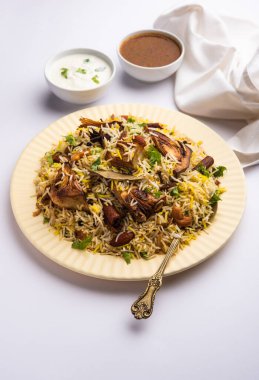 Kathal Biryani is made using raw jackfruit pieces cooked slowly with a variety of spices and mixed with basmati rice. served with curd and salan. Indian vegetarian food