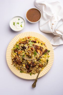 Kathal Biryani is made using raw jackfruit pieces cooked slowly with a variety of spices and mixed with basmati rice. served with curd and salan. Indian vegetarian food