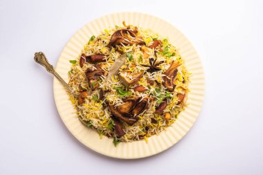 Kathal Biryani is made using raw jackfruit pieces cooked slowly with a variety of spices and mixed with basmati rice. served with curd and salan. Indian vegetarian food