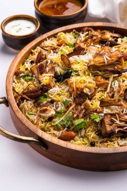 Kathal Biryani is made using raw jackfruit pieces cooked slowly with a variety of spices and mixed with basmati rice. served with curd and salan. Indian vegetarian food