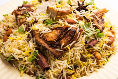 Kathal Biryani is made using raw jackfruit pieces cooked slowly with a variety of spices and mixed with basmati rice. served with curd and salan. Indian vegetarian food