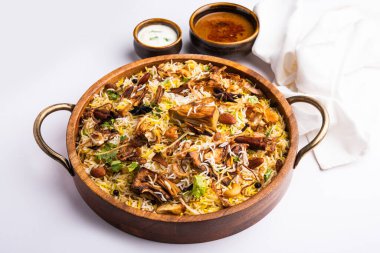 Kathal Biryani is made using raw jackfruit pieces cooked slowly with a variety of spices and mixed with basmati rice. served with curd and salan. Indian vegetarian food