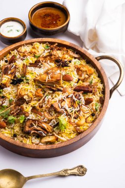 Kathal Biryani is made using raw jackfruit pieces cooked slowly with a variety of spices and mixed with basmati rice. served with curd and salan. Indian vegetarian food
