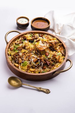 Kathal Biryani is made using raw jackfruit pieces cooked slowly with a variety of spices and mixed with basmati rice. served with curd and salan. Indian vegetarian food