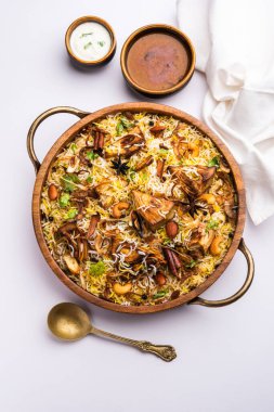 Kathal Biryani is made using raw jackfruit pieces cooked slowly with a variety of spices and mixed with basmati rice. served with curd and salan. Indian vegetarian food