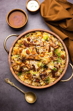 Kathal Biryani is made using raw jackfruit pieces cooked slowly with a variety of spices and mixed with basmati rice. served with curd and salan. Indian vegetarian food