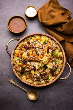 Kathal Biryani is made using raw jackfruit pieces cooked slowly with a variety of spices and mixed with basmati rice. served with curd and salan. Indian vegetarian food