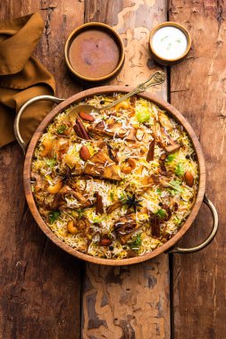 Kathal Biryani is made using raw jackfruit pieces cooked slowly with a variety of spices and mixed with basmati rice. served with curd and salan. Indian vegetarian food