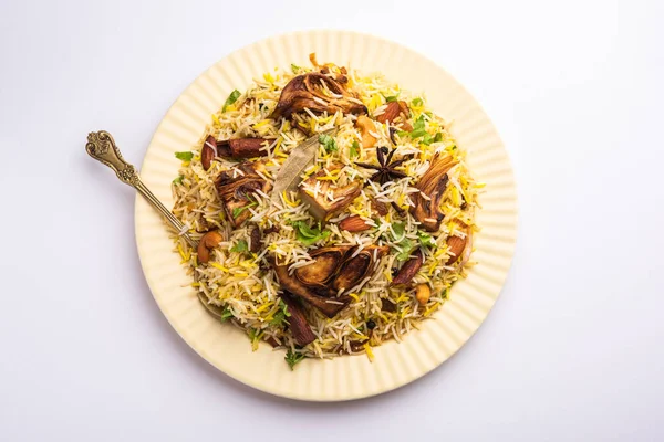 Kathal Biryani is made using raw jackfruit pieces cooked slowly with a variety of spices and mixed with basmati rice. served with curd and salan. Indian vegetarian food