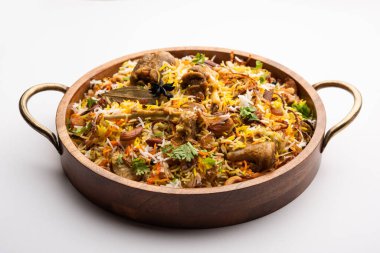 Indian Mutton biryani prepared in Basmati Rice served with Yogurt dip over moody background, Selective focus