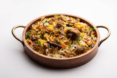 Indian Mutton biryani prepared in Basmati Rice served with Yogurt dip over moody background, Selective focus