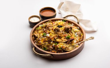 Indian Mutton biryani prepared in Basmati Rice served with Yogurt dip over moody background, Selective focus