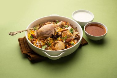 Restaurant style Spicy Chicken Biryani served with Raita and Salan, Popular Indian or Pakistani non vegetarian Food
