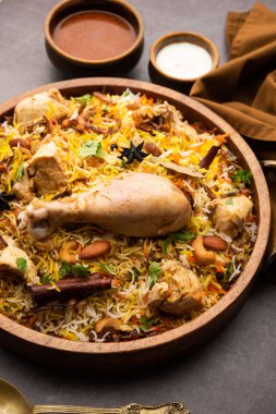 Restaurant style Spicy Chicken Biryani served with Raita and Salan, Popular Indian or Pakistani non vegetarian Food