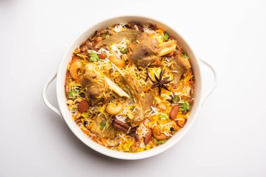 Indian Mutton biryani prepared in Basmati Rice served with Yogurt dip over moody background, Selective focus