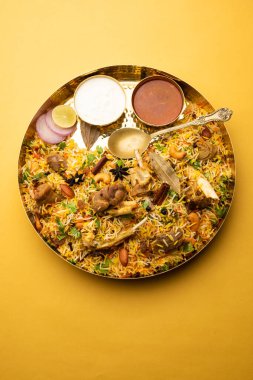 Indian Mutton biryani prepared in Basmati Rice served with Yogurt dip over moody background, Selective focus