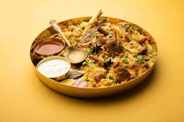 Indian Mutton biryani prepared in Basmati Rice served with Yogurt dip over moody background, Selective focus