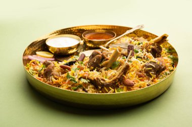 Indian Mutton biryani prepared in Basmati Rice served with Yogurt dip over moody background, Selective focus