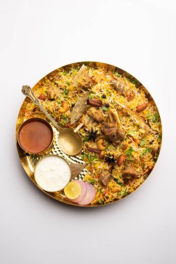 Indian Mutton biryani prepared in Basmati Rice served with Yogurt dip over moody background, Selective focus