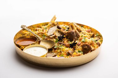 Indian Mutton biryani prepared in Basmati Rice served with Yogurt dip over moody background, Selective focus
