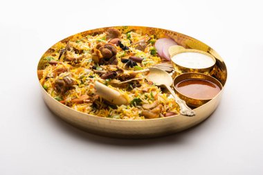 Indian Mutton biryani prepared in Basmati Rice served with Yogurt dip over moody background, Selective focus