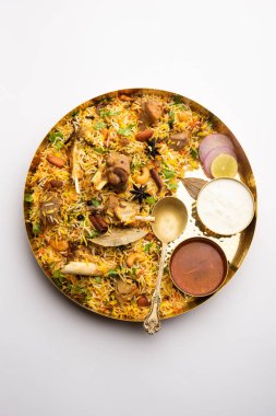 Indian Mutton biryani prepared in Basmati Rice served with Yogurt dip over moody background, Selective focus