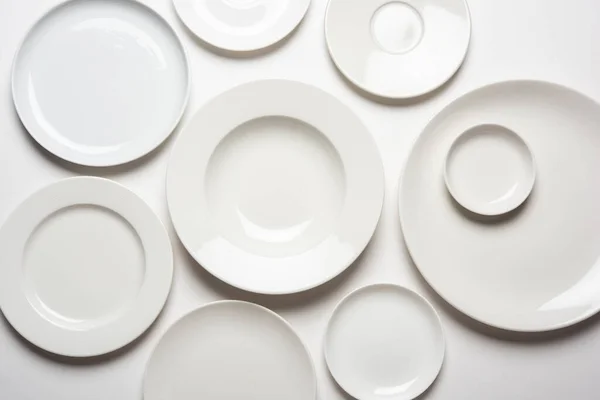 Διαφορετικά Σχήματα Λευκά Πιάτα Που Απομονώνονται Λευκό Φόντο Πάνω Όψη — Φωτογραφία Αρχείου