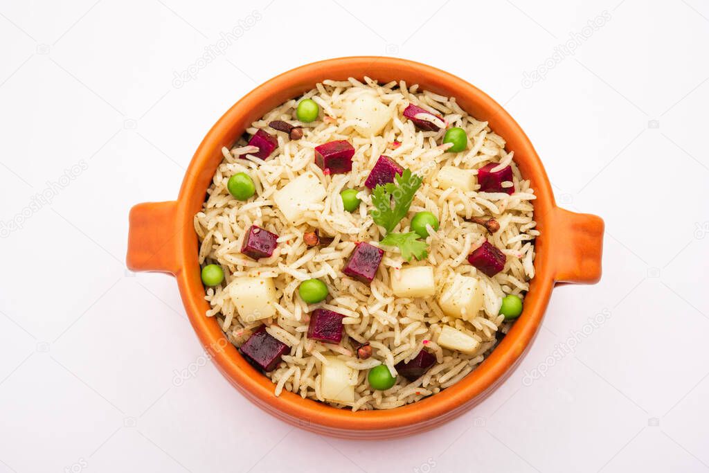 Beetroot Rice or pulao or pulav served in a bowl or karahi, selective focus. Indian food