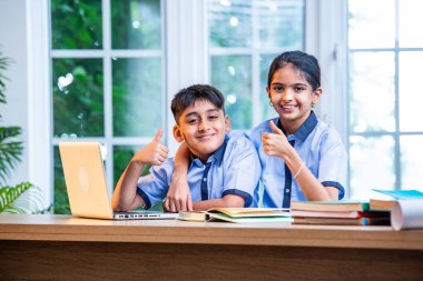 Sınıf Üniformalarını Giyerken Dizüstü Bilgisayarda Birlikte Çalışan Hintli Okul Çocukları, Grup Öğrenimi, Bilgi Paylaşımı, Eğitim sırasında Akademik Görevler Kullanımı Teknolojisi İşbirliği
