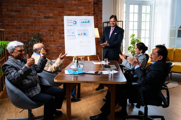 Hintli işadamları, Hindistan 'ın Asya iş dünyasının üst düzey yöneticileri olarak, şirket büyümesini ve finansal projeksiyon stratejisini modern ofiste incelerken, grafikte tartışıyorlar.