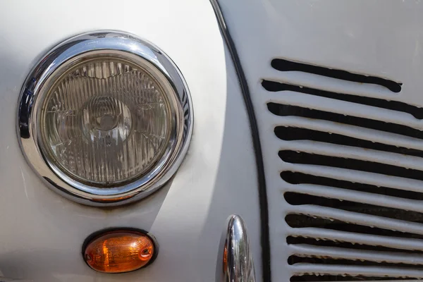 close up of a vintage white car headlight