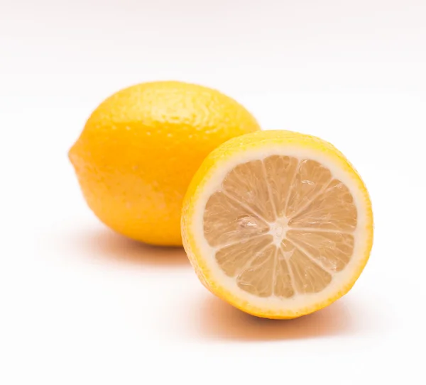 Lemon in a cut and whole on a light background Royalty Free Stock Photos