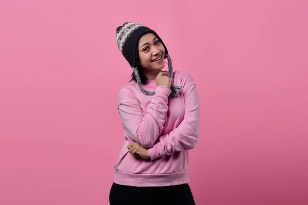 ピンクの背景に隔離された帽子の上にロープを保持両手で空の空間を広く見て笑顔アジアの女性の肖像画 — ストック写真