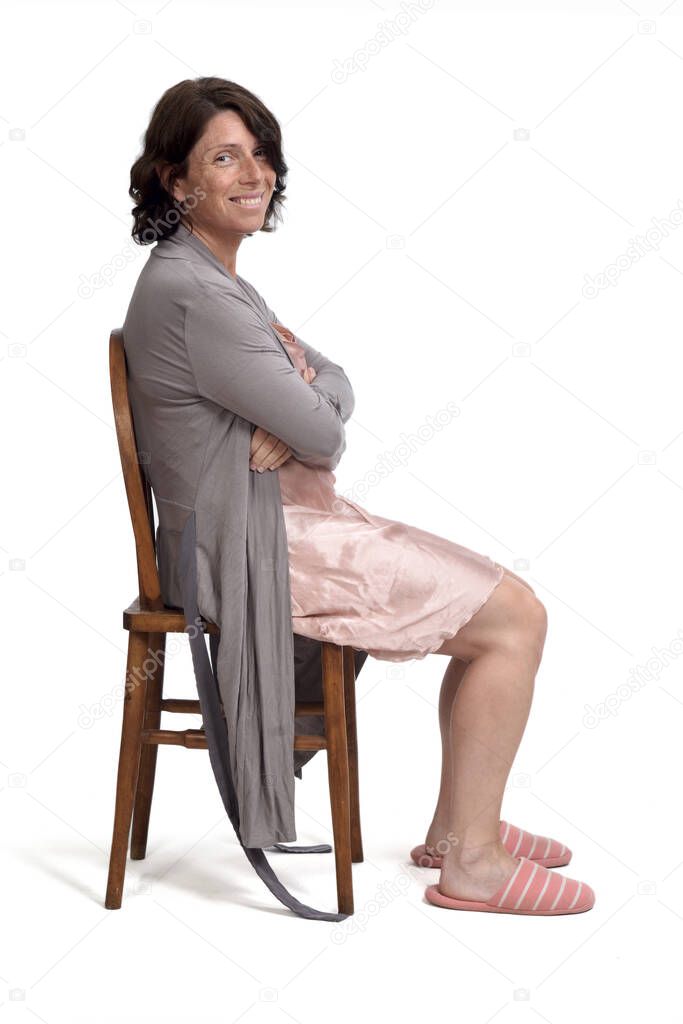 side view of a woman sitting dressing gown on white background, 