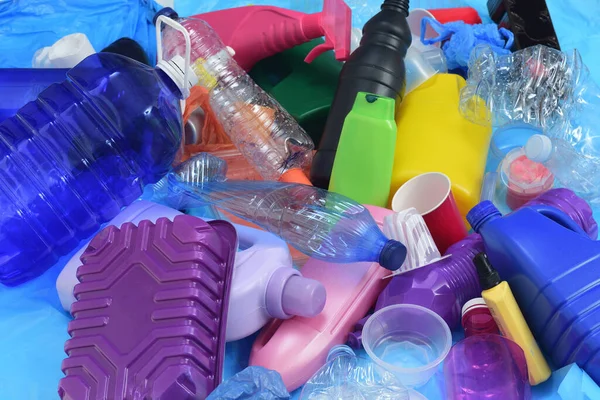 close up of a group of plastic containers on blue plastic bags
